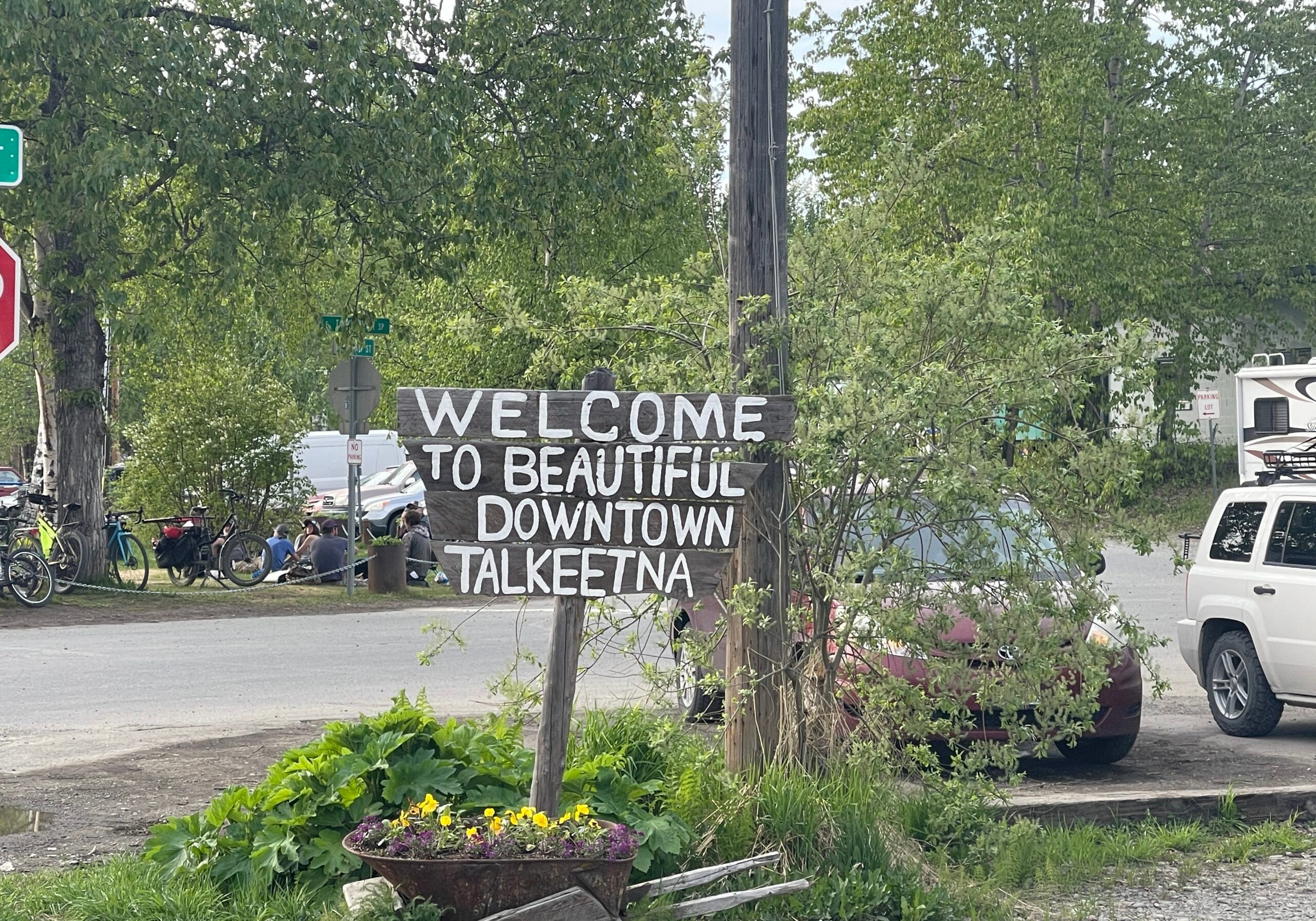 Welcome sign at the entrance to Talkeetna Alaska surrounded by trees, representing the character and appeal of the local community.